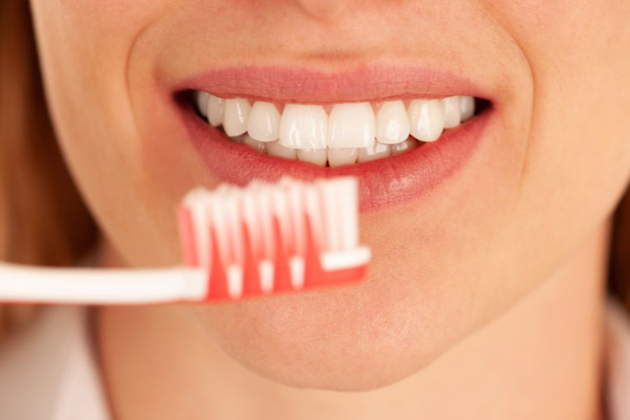 woman brushing her teeth