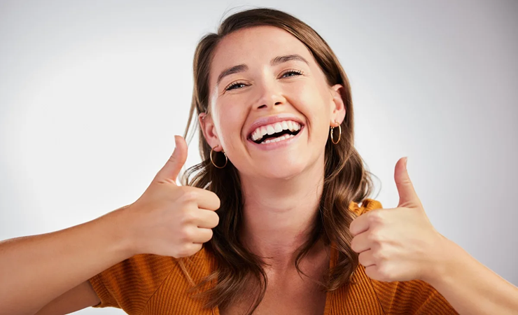 a happy woman smiling after restorative dental treatment